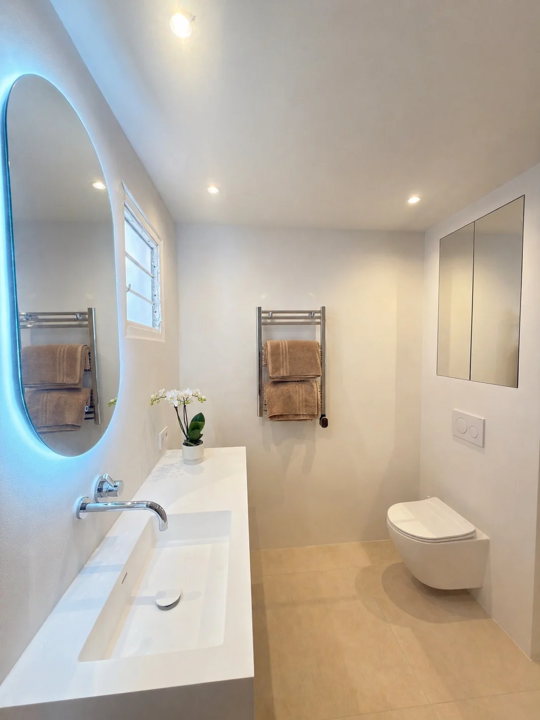 Modern white bathroom with floating vanity and wall-hung toilet